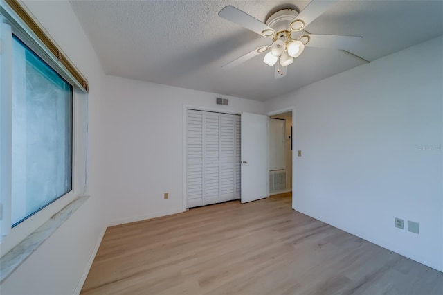 empty room featuring ceiling fan and light hardwood / wood-style floors