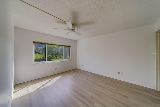 unfurnished room with light hardwood / wood-style flooring, a textured ceiling, and ceiling fan