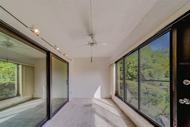 sunroom featuring ceiling fan