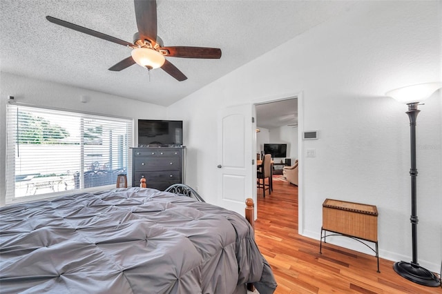 bedroom with vaulted ceiling, hardwood / wood-style floors, and ceiling fan