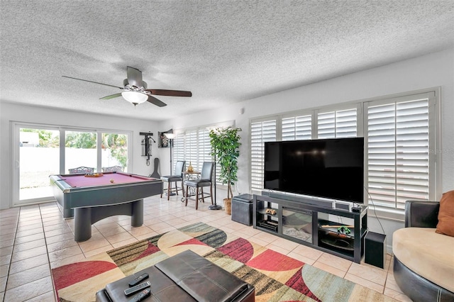 game room with a textured ceiling, ceiling fan, light tile patterned floors, and pool table