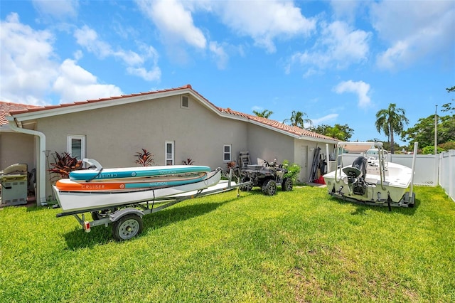 rear view of house featuring a lawn