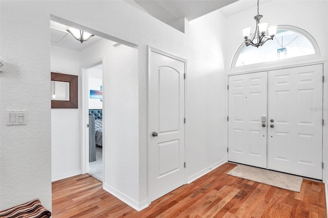 entryway featuring a notable chandelier and hardwood / wood-style floors