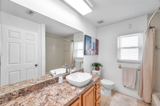 full bathroom featuring plenty of natural light, vanity, shower / bath combo, and tile patterned floors