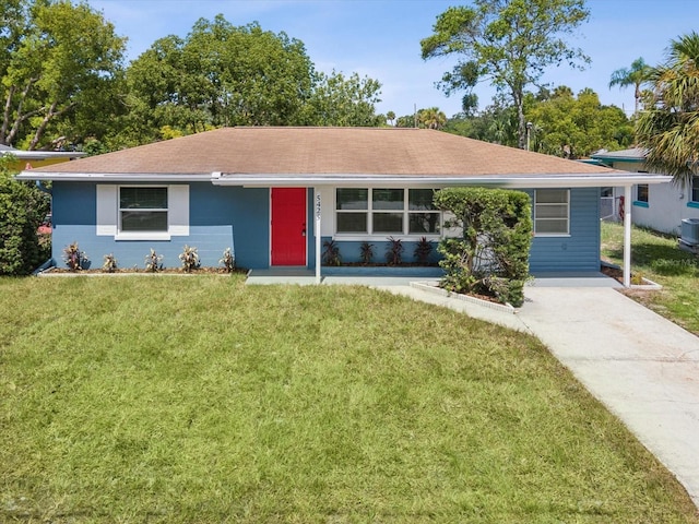 single story home with central AC unit, a front yard, and a carport