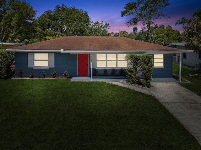 ranch-style house featuring a yard