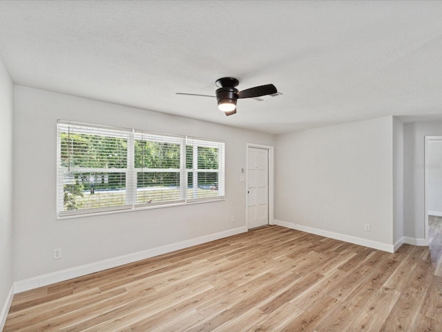 spare room with light hardwood / wood-style floors and ceiling fan