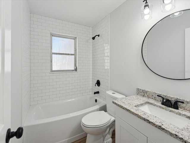 full bathroom with tiled shower / bath combo, vanity, and toilet