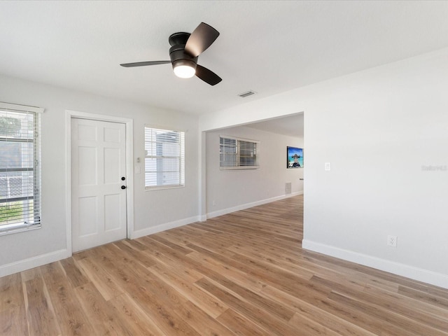 interior space featuring ceiling fan, light hardwood / wood-style floors, and a healthy amount of sunlight