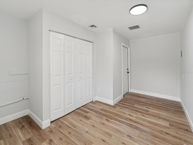 unfurnished bedroom with light wood-type flooring