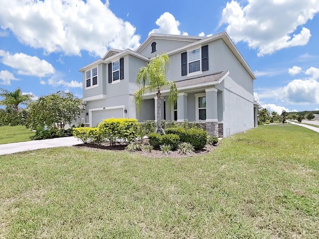 view of front of property featuring a front yard and a garage