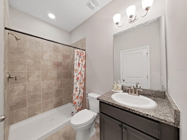 bathroom with a stall shower, visible vents, vanity, and toilet