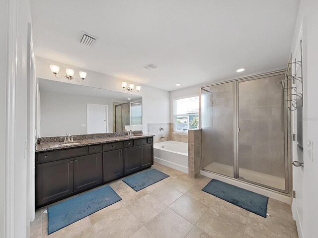 bathroom featuring tile patterned flooring, plus walk in shower, and vanity