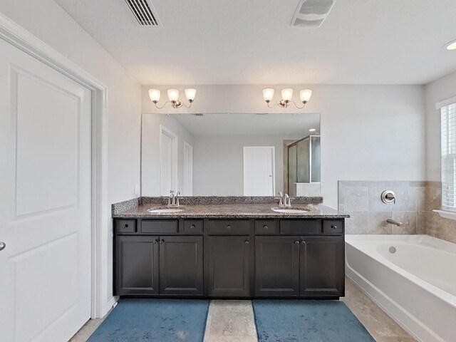 bathroom featuring tile patterned floors, plus walk in shower, and vanity