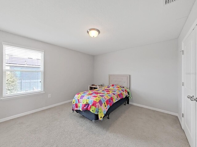 carpeted bedroom featuring baseboards