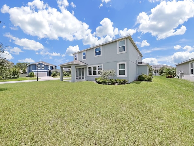 back of house with a yard, stucco siding, a carport, a residential view, and driveway