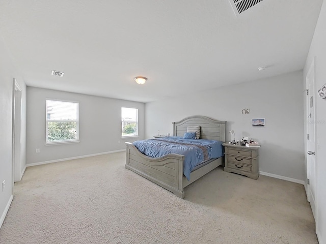 bedroom with light carpet, baseboards, and visible vents