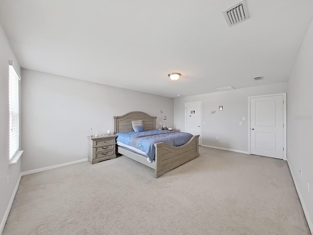 unfurnished bedroom featuring light carpet, baseboards, and visible vents