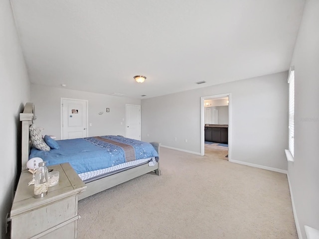 bedroom with light colored carpet and baseboards