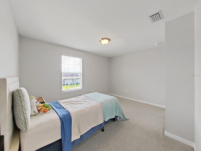 carpeted bedroom with baseboards and visible vents