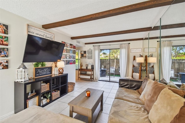 tiled living room with beamed ceiling, a textured ceiling, and a healthy amount of sunlight