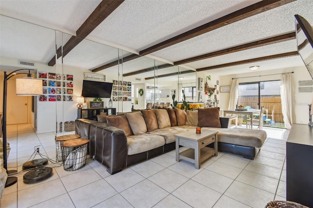 tiled living room featuring beamed ceiling and a textured ceiling