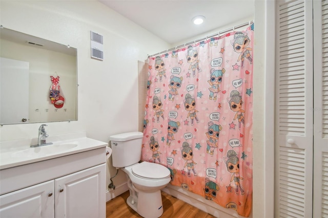 bathroom featuring vanity, toilet, and hardwood / wood-style floors