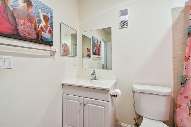 bathroom featuring vanity and toilet