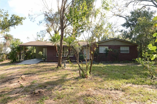 ranch-style house with a front lawn and a carport