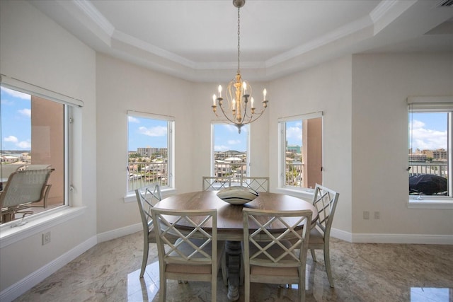 dining room featuring a tray ceiling, ornamental molding, and a healthy amount of sunlight