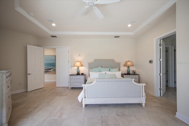 bedroom featuring ceiling fan and a tray ceiling