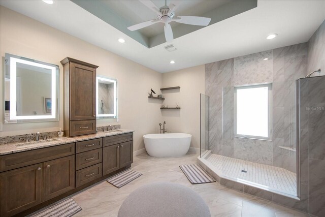 bathroom with ceiling fan, vanity, and separate shower and tub