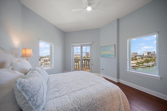 bedroom featuring ceiling fan, a water view, access to outside, and dark hardwood / wood-style flooring