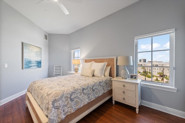 bedroom with dark hardwood / wood-style flooring and ceiling fan