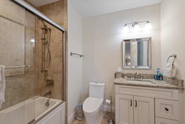 full bathroom featuring vanity, combined bath / shower with glass door, and toilet