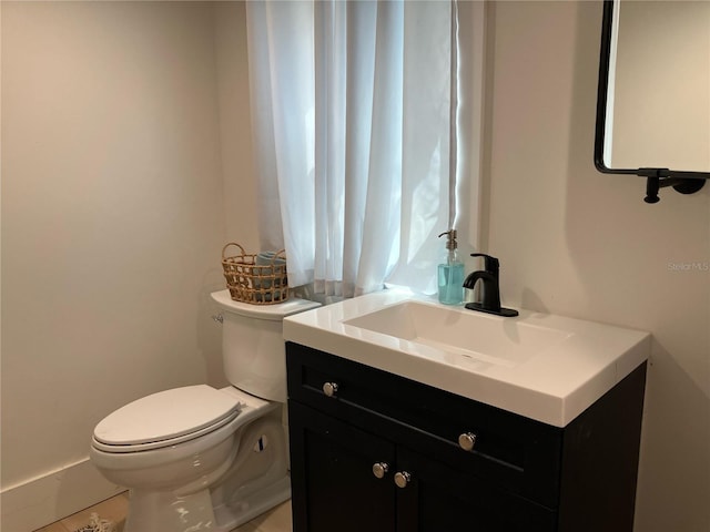 bathroom with toilet and vanity