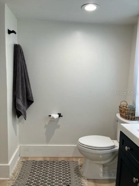 bathroom featuring vanity, toilet, and tile patterned flooring