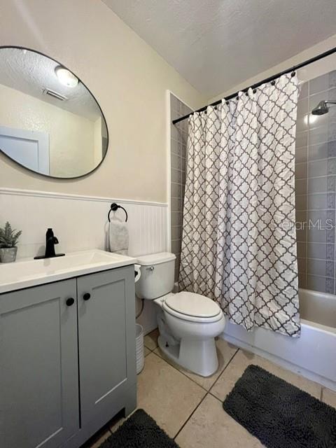 full bathroom with vanity, toilet, shower / tub combo with curtain, and tile patterned flooring