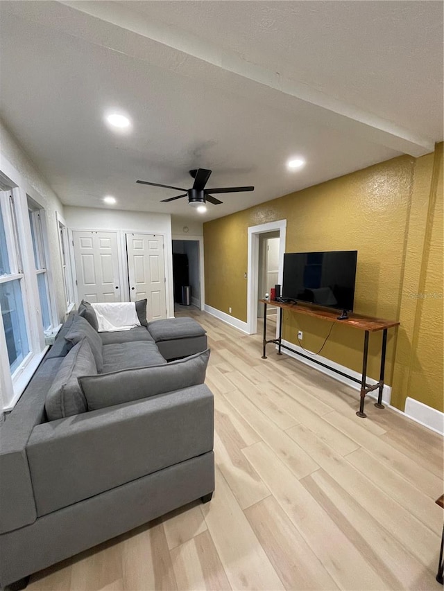 living room featuring ceiling fan and light hardwood / wood-style floors