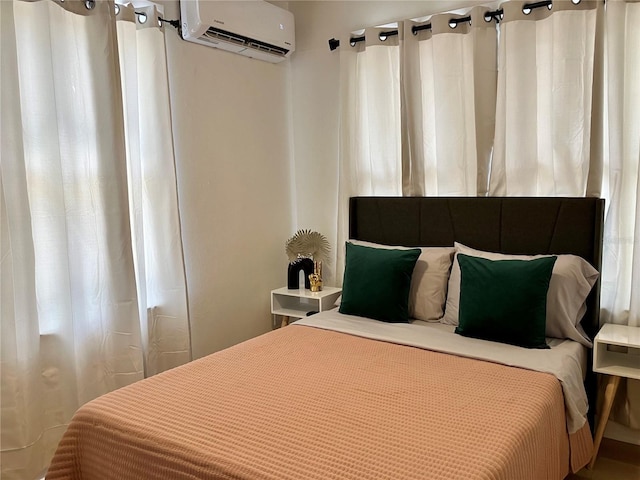 bedroom with a wall mounted AC