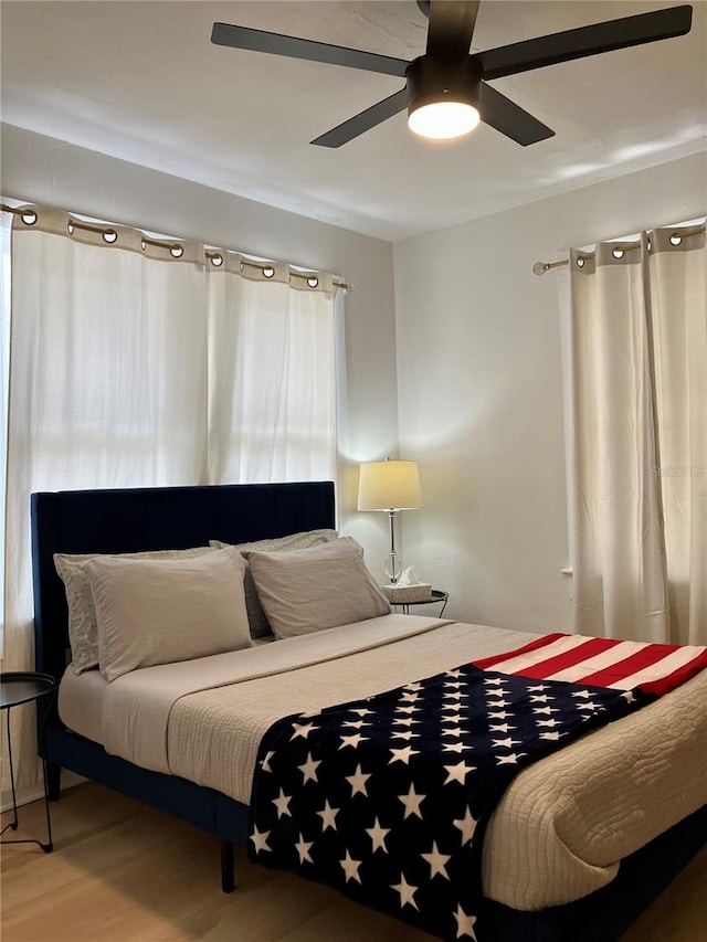 bedroom featuring wood-type flooring and ceiling fan