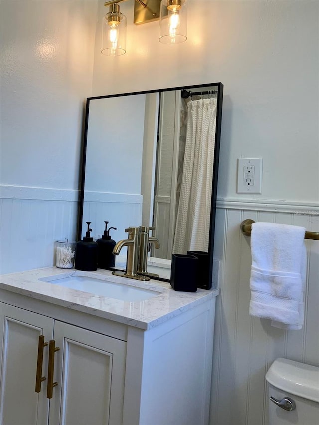 bathroom featuring toilet and vanity