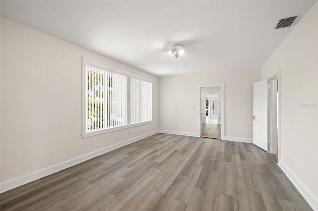 unfurnished room with wood-type flooring