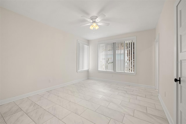 tiled spare room with ceiling fan