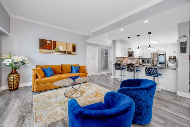 living room featuring light hardwood / wood-style floors and ornamental molding