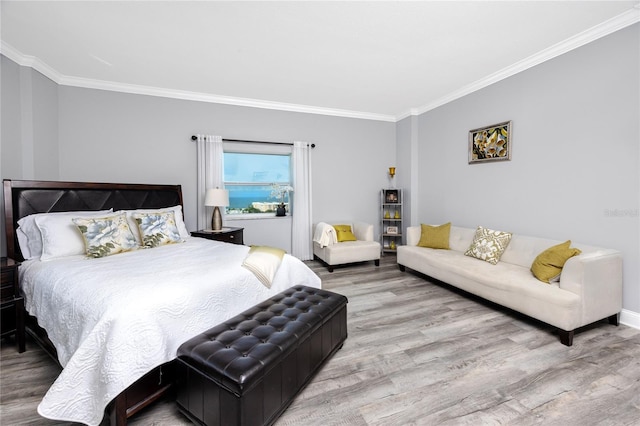 bedroom with hardwood / wood-style flooring and crown molding