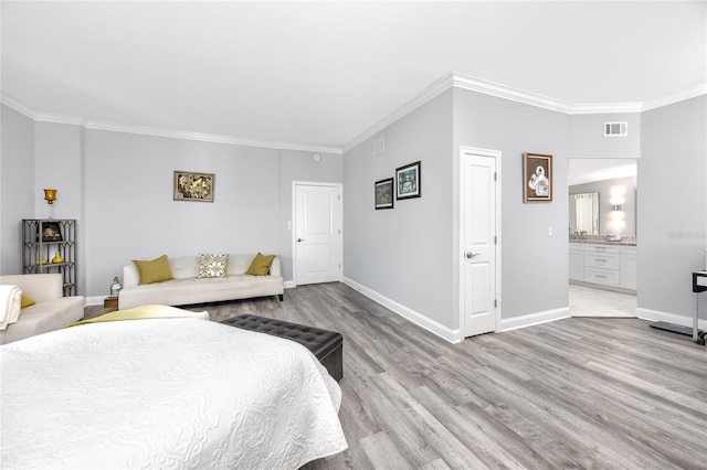 bedroom with ornamental molding, light wood finished floors, visible vents, and baseboards