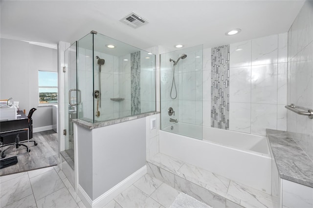 bathroom with a washtub and hardwood / wood-style floors