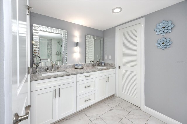 bathroom featuring tile patterned flooring, double sink vanity, and an enclosed shower