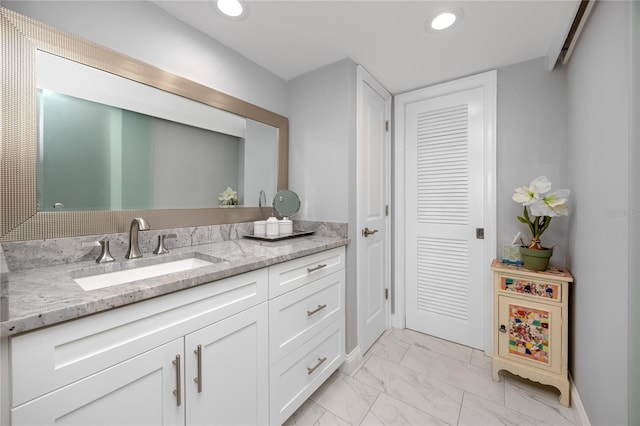 bathroom featuring marble finish floor, vanity, and recessed lighting